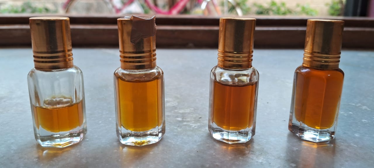Vetriver roots with amber essential oil vial in natural light